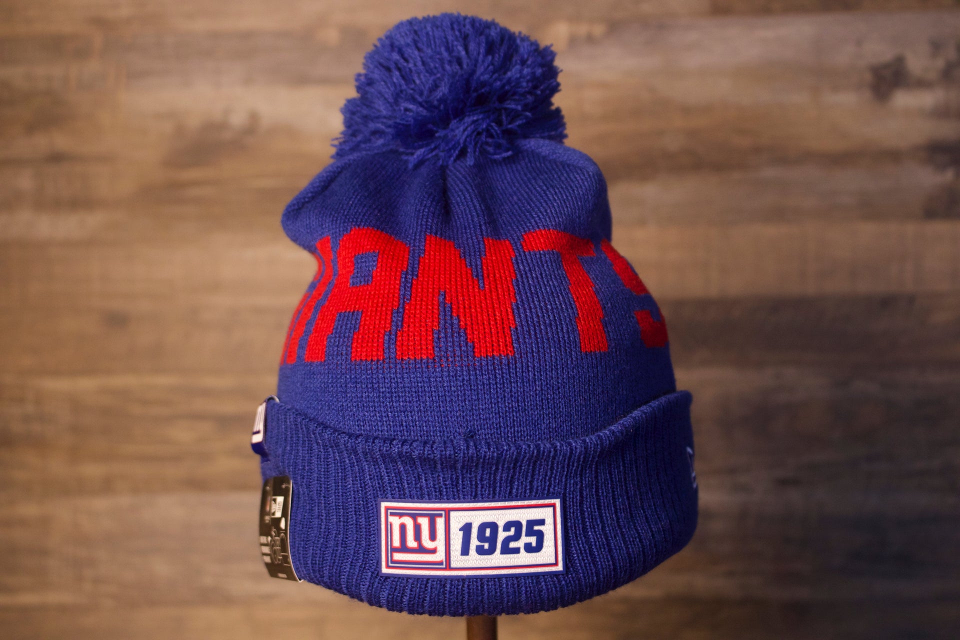 Giants Beanie | New York Giants 2019 On-Field Beanie | Giants Blue Winter Hat  on the front of the sideline giants 2019 beanie is the year the giants were founded and the name giants in red