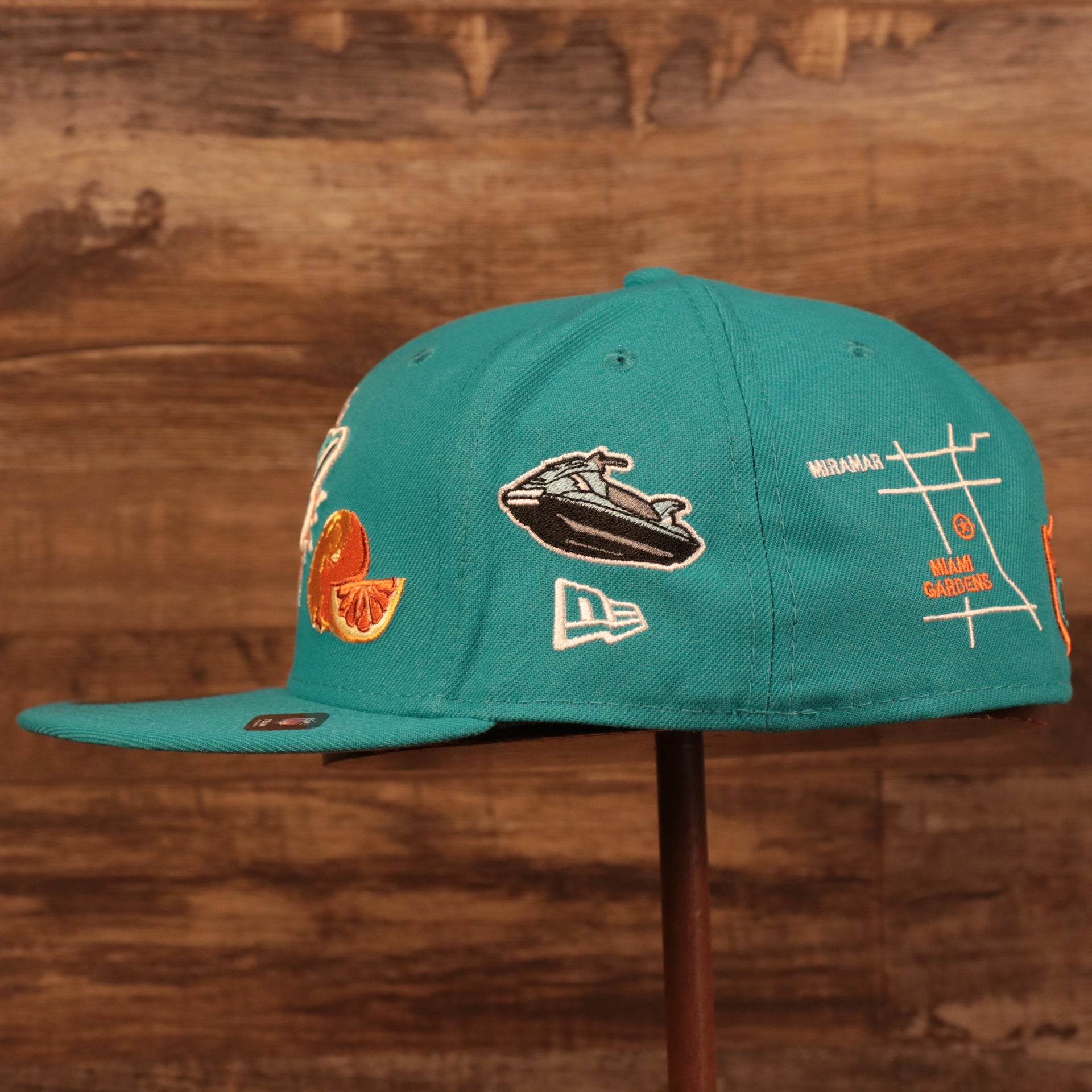 Wearer's left of the Miami Dolphins City Transit All Over Side Patch Gray Bottom 59Fifty Fitted Cap