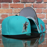 front and bottom of the Florida Marlins Cooperstown 1997 World Series Side Patch Grey Bottom 59Fifty Fitted Cap | Teal