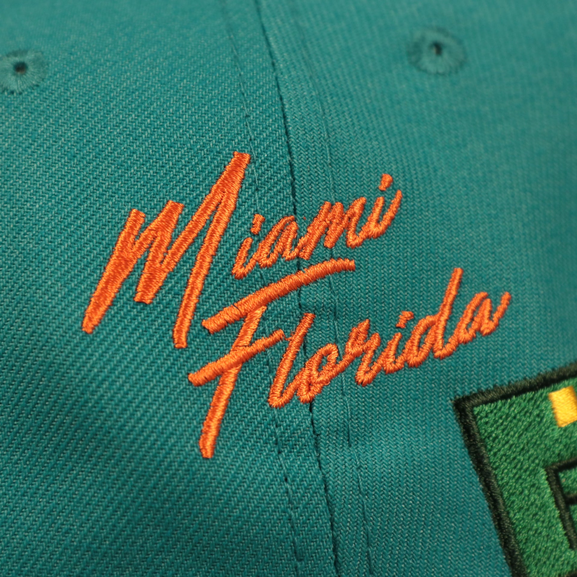 Miami Florida script on the side of the Miami Dolphins City Transit All Over Side Patch Gray Bottom 59Fifty Fitted Cap