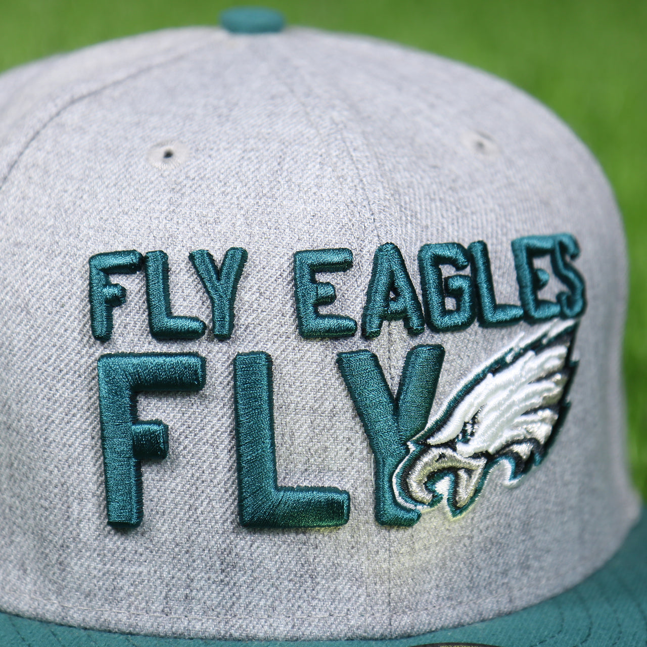 fly eagles fly logo on the front of the Philadelphia Eagles 2018 On-Stage Draft 59Fifty Green Bottom Fitted Cap