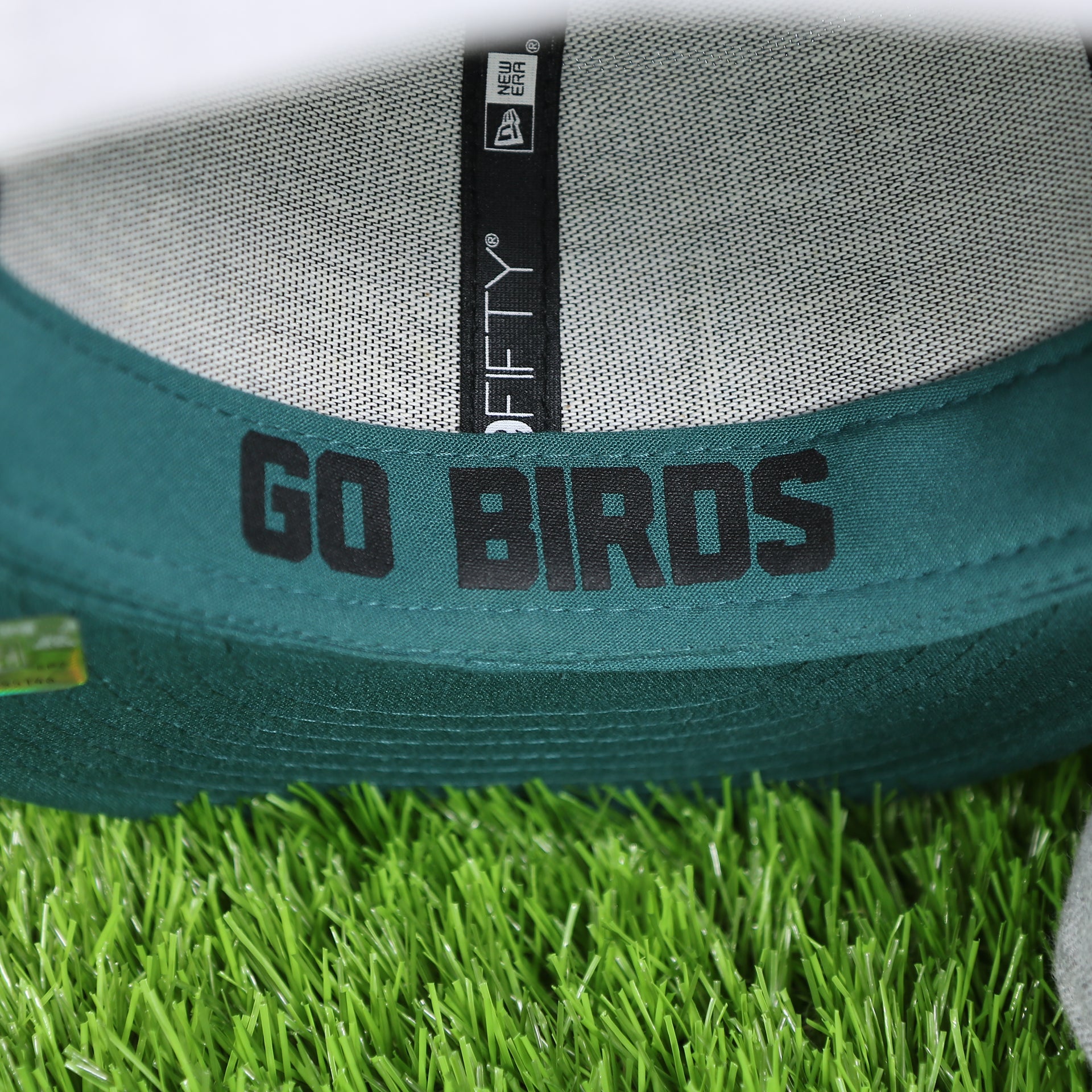 go birds on the inside sweatband of the Philadelphia Eagles 2018 On-Stage Draft 59Fifty Green Bottom Fitted Cap