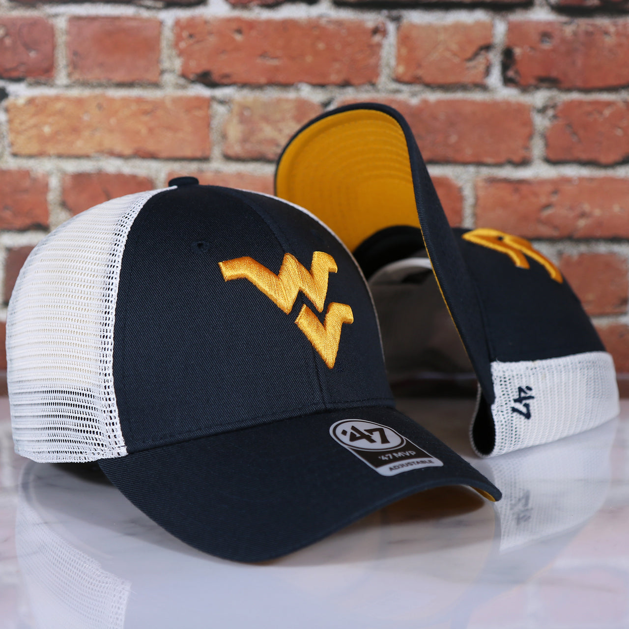 front and bottom of the West Virginia Mountaineers MVP Yellow Bottom Trucker Cap | Navy/White | OSFM