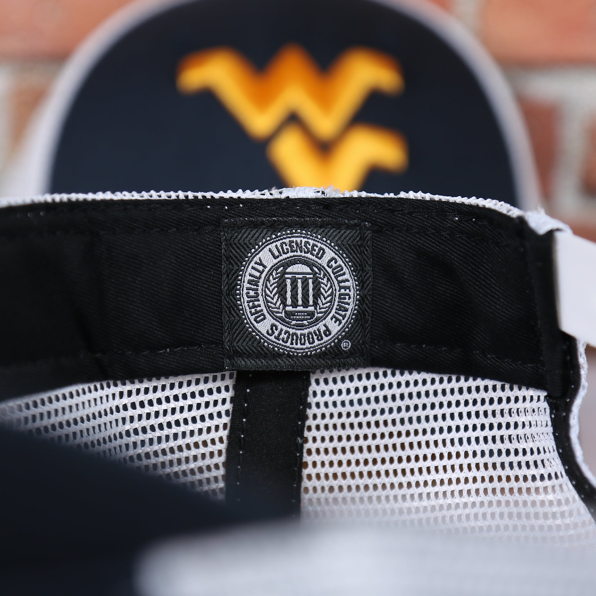 college product tag on the inside of the West Virginia Mountaineers MVP Yellow Bottom Trucker Cap | Navy/White | OSFM
