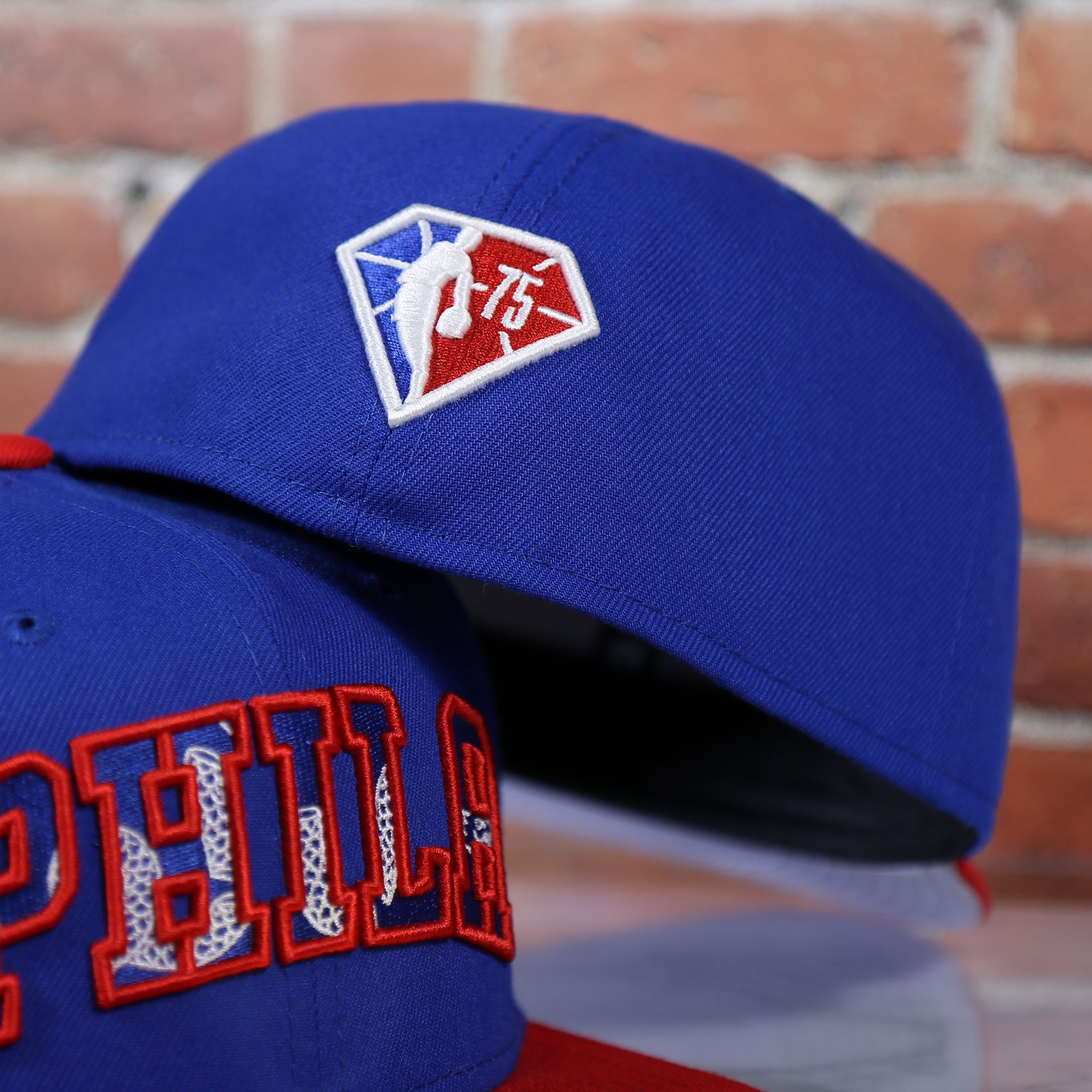NBA 75 logo on the backside of the Philadelphia 76ers 2021 NBA Draft 59Fifty Fitted Cap | Blue/Red