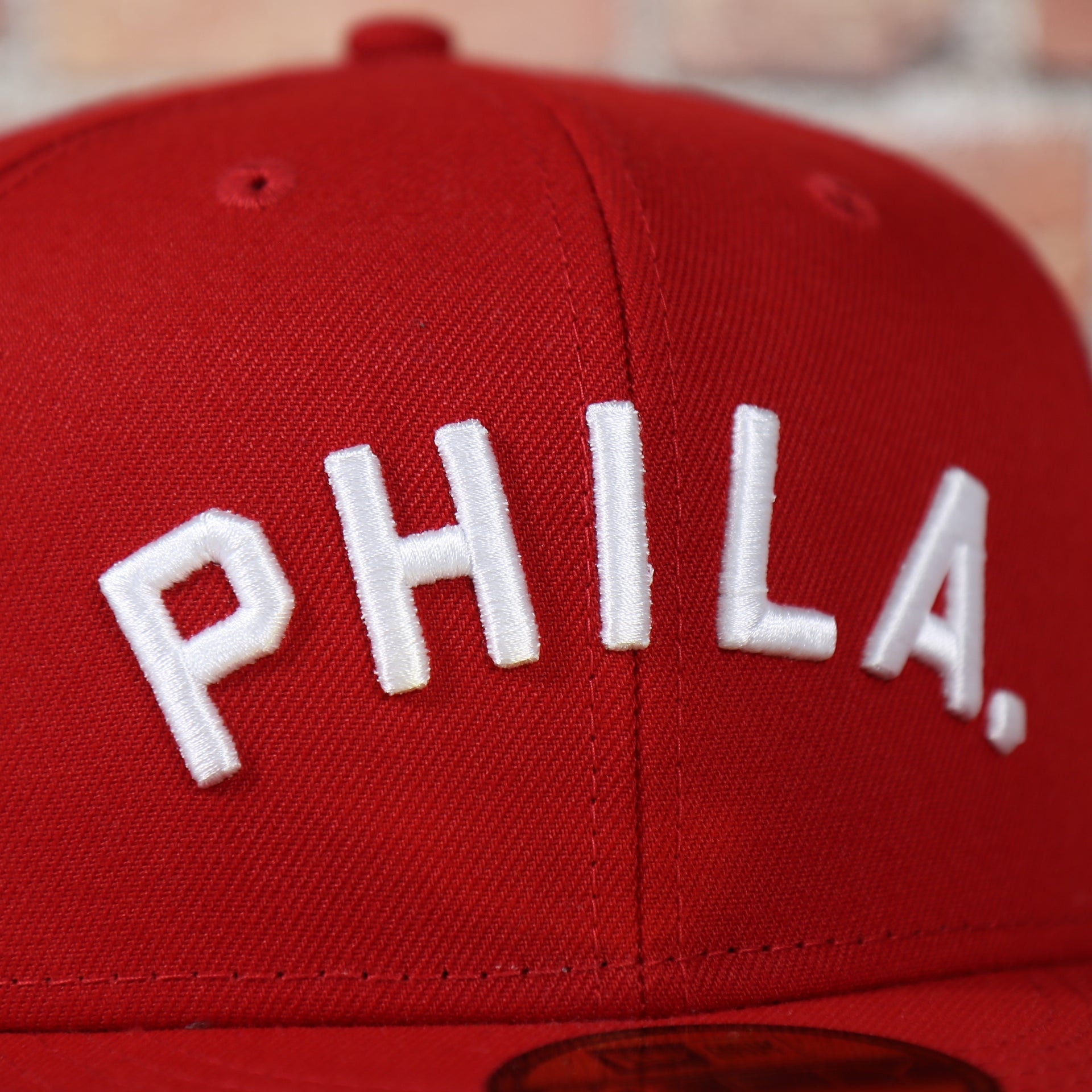 phila lettering on the Philadelphia Phillies Arched "PHILA" Lettering 59Fifty Fitted Cap | Old School Phillies Red Bottom New Era Fitted Hat