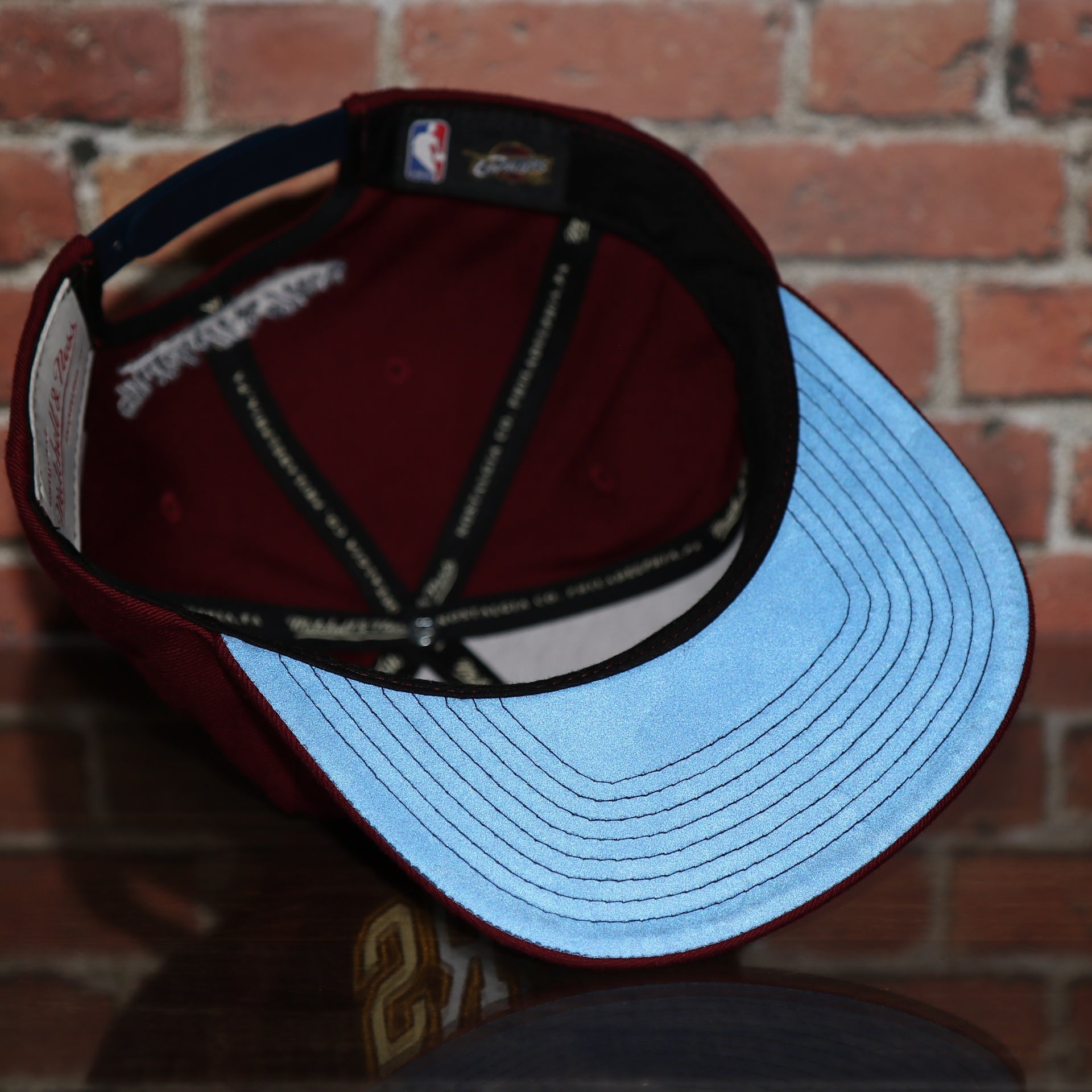 reflective under visor on the Cleveland Cavaliers Reflective Lettering Maroon Snapback Hat