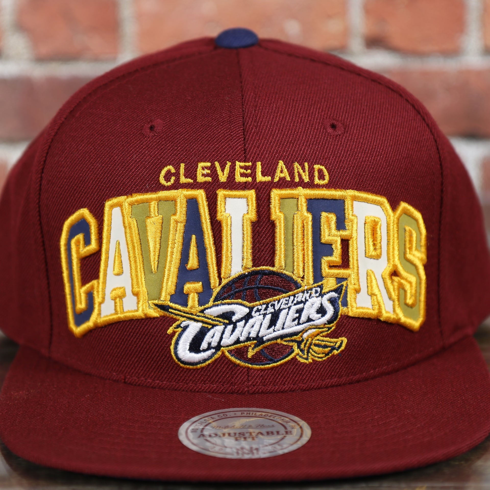 cavaliers logo and lettering on the Cleveland Cavaliers Reflective Lettering Maroon Snapback Hat
