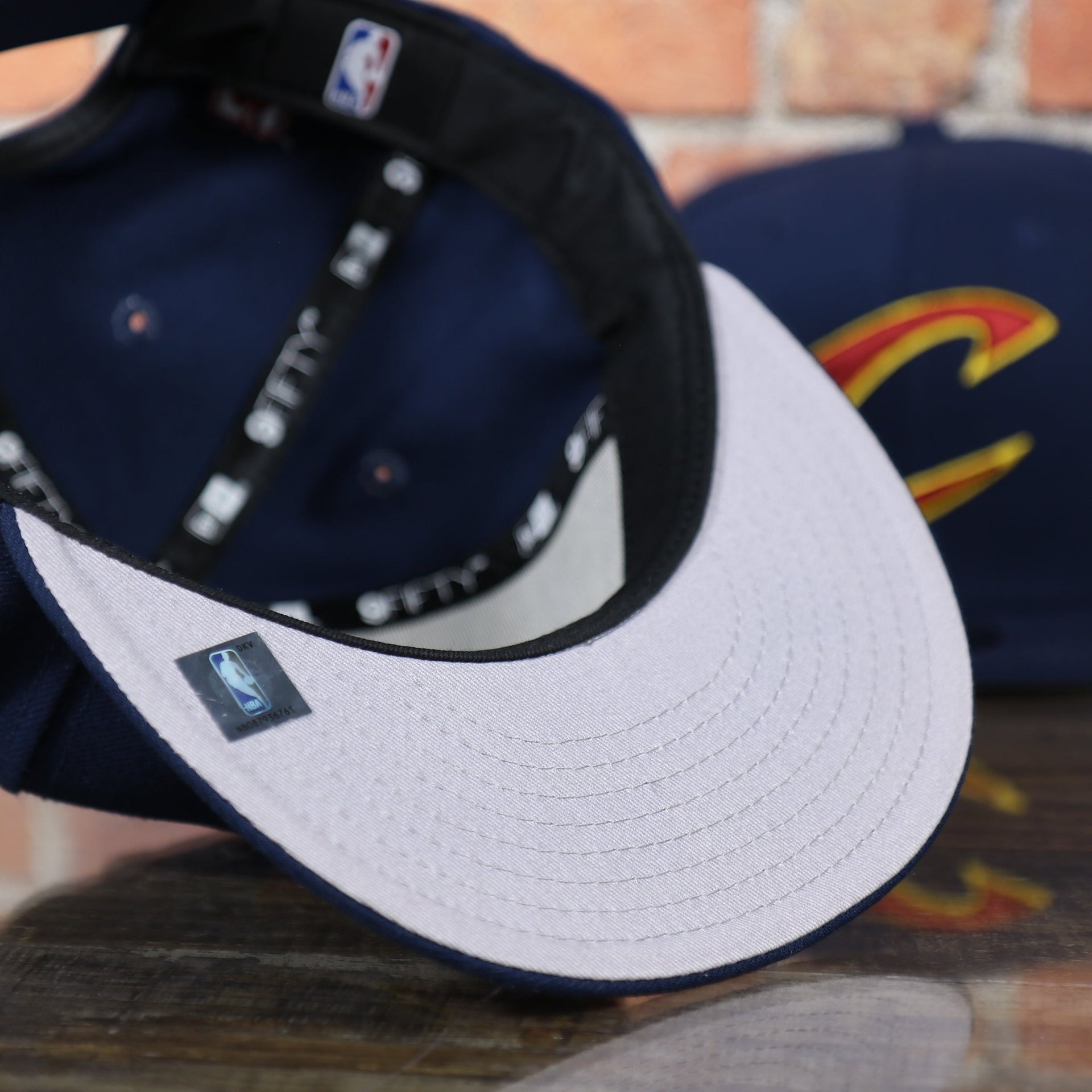 grey under visor on the Cleveland Cavaliers Classic Navy Blue Snapback Hat
