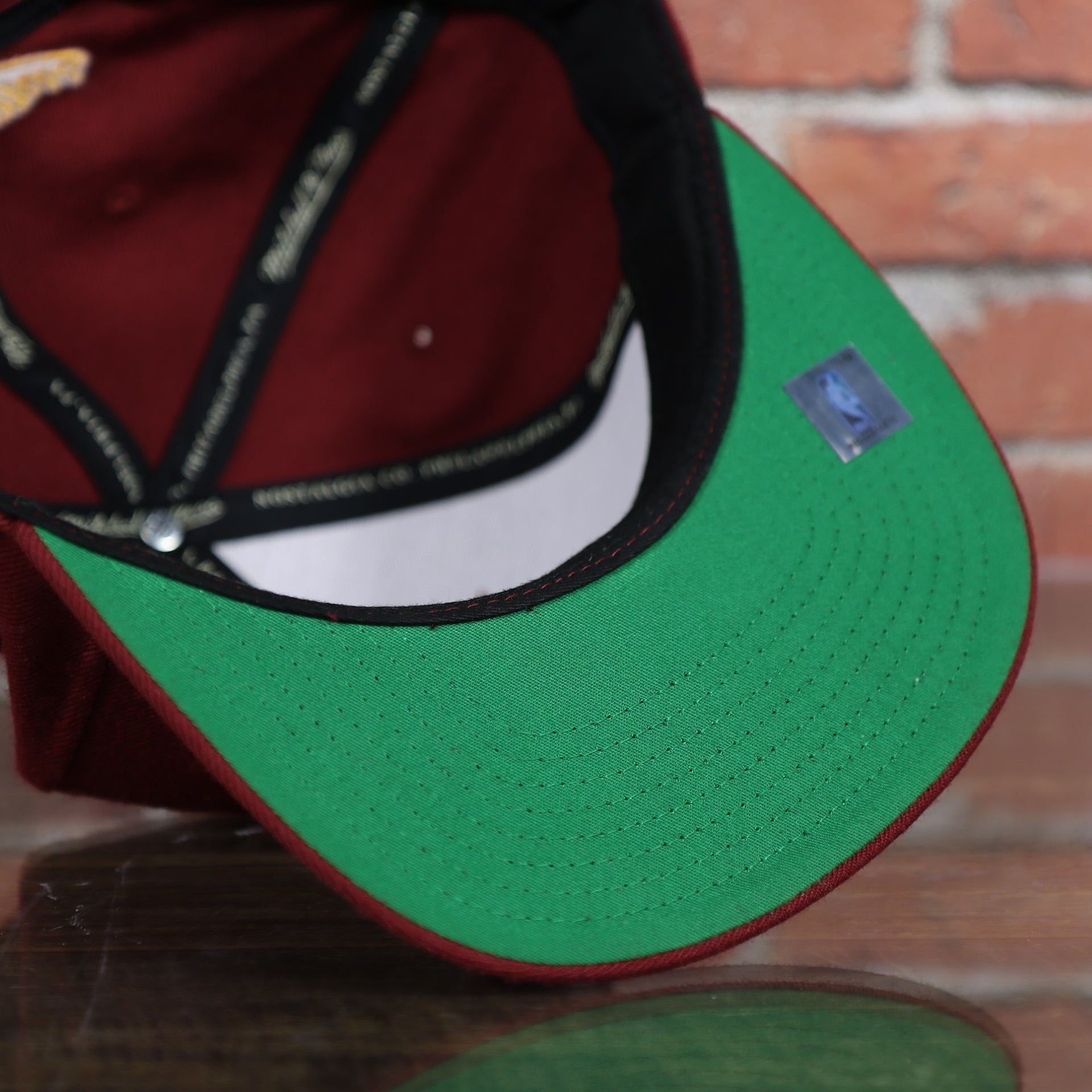green under visor on the Cleveland Cavaliers Classic Maroon Snapback Hat