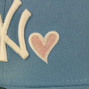 Close up of the heart embroidery on the New York Yankees Glow In The Dark 27x World Series Champs Patch Pink Bottom Side Patch 59Fifty Fitted Cap