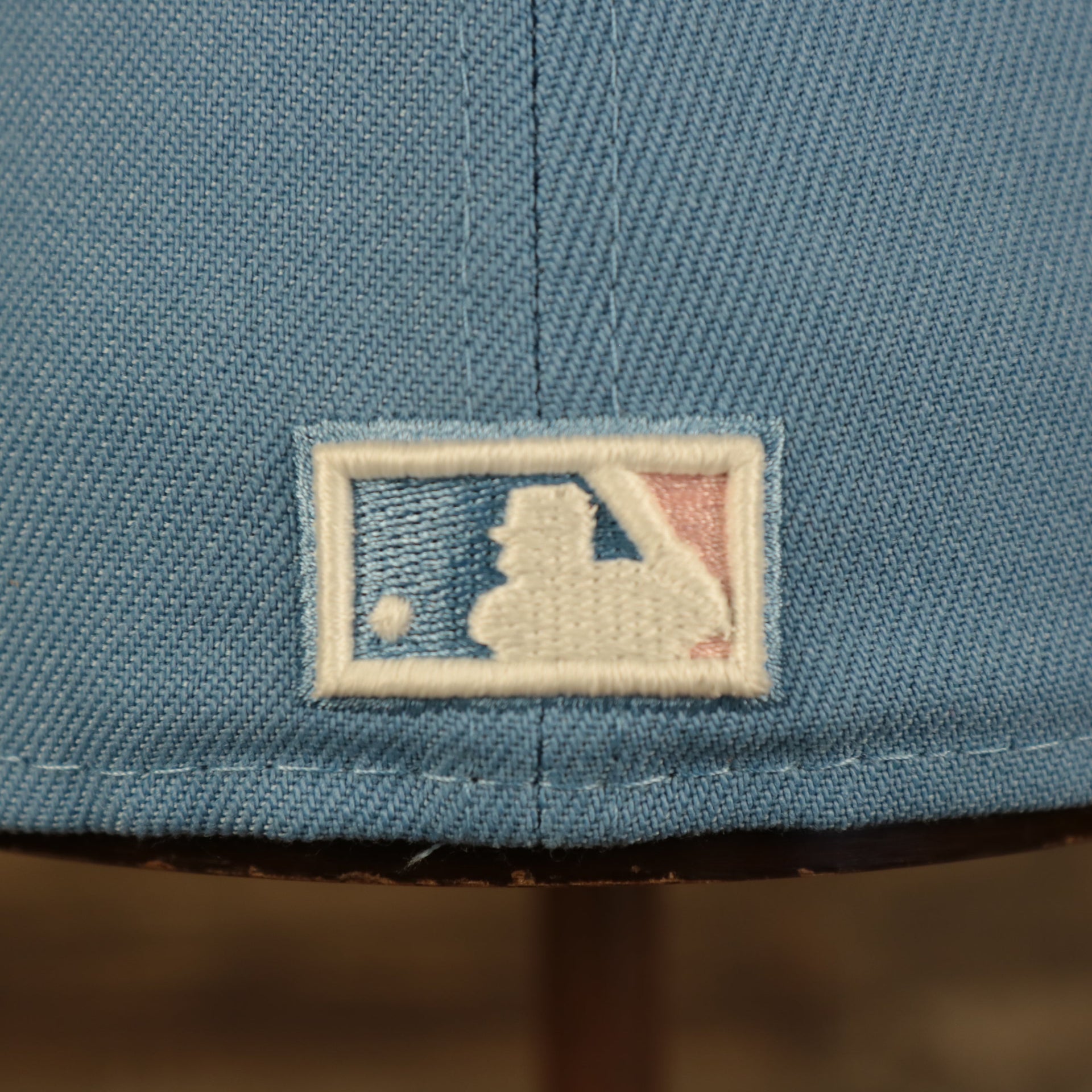 Close up of the MLB Batterman logo on the New York Yankees Glow In The Dark 27x World Series Champs Patch Pink Bottom Side Patch 59Fifty Fitted Cap