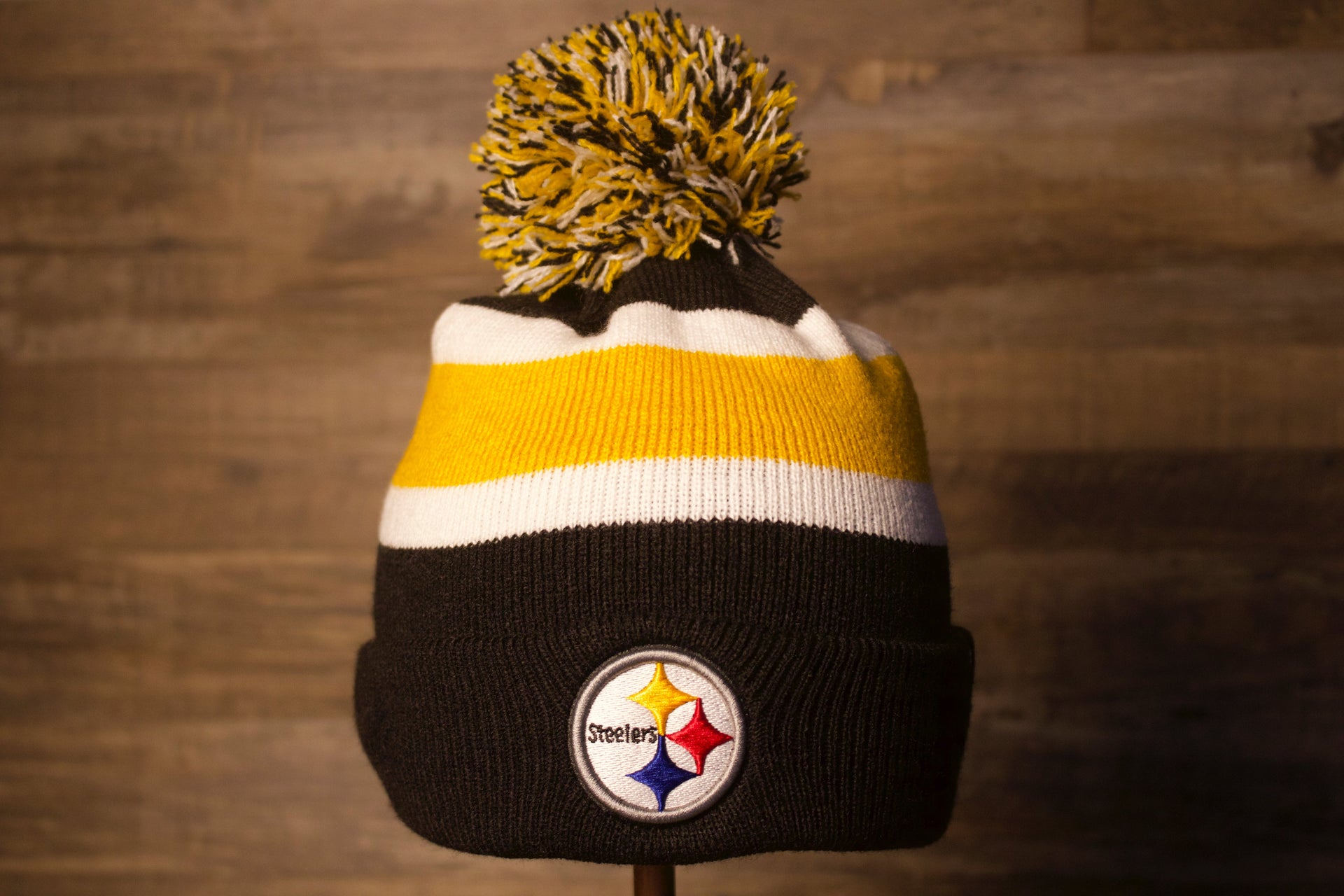 Steelers Beanie | Pittsburgh Steelers Striped Winter Hat the front of this steelers beanie is black with a white and yellow stripe with a black white and yellow pom