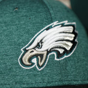 eagles logo on the Philadelphia Eagles Onfield NFL Sideline Side Patch 39Thirty Flexfit Cap | Midnight Green 39Thirty Cap