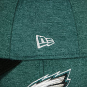 new era logo on the Philadelphia Eagles Onfield NFL Sideline Side Patch 39Thirty Flexfit Cap | Midnight Green 39Thirty Cap