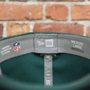 new era label on the Philadelphia Eagles Onfield NFL Sideline Side Patch 39Thirty Flexfit Cap | Midnight Green 39Thirty Cap