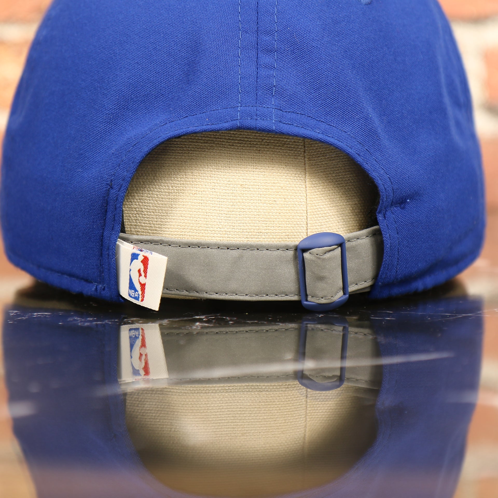 grey adjustable strap on the Golden State Warriors NBA Draft 9Twenty Dad Hat With Suede Visor | Royal Blue Baseball Hat