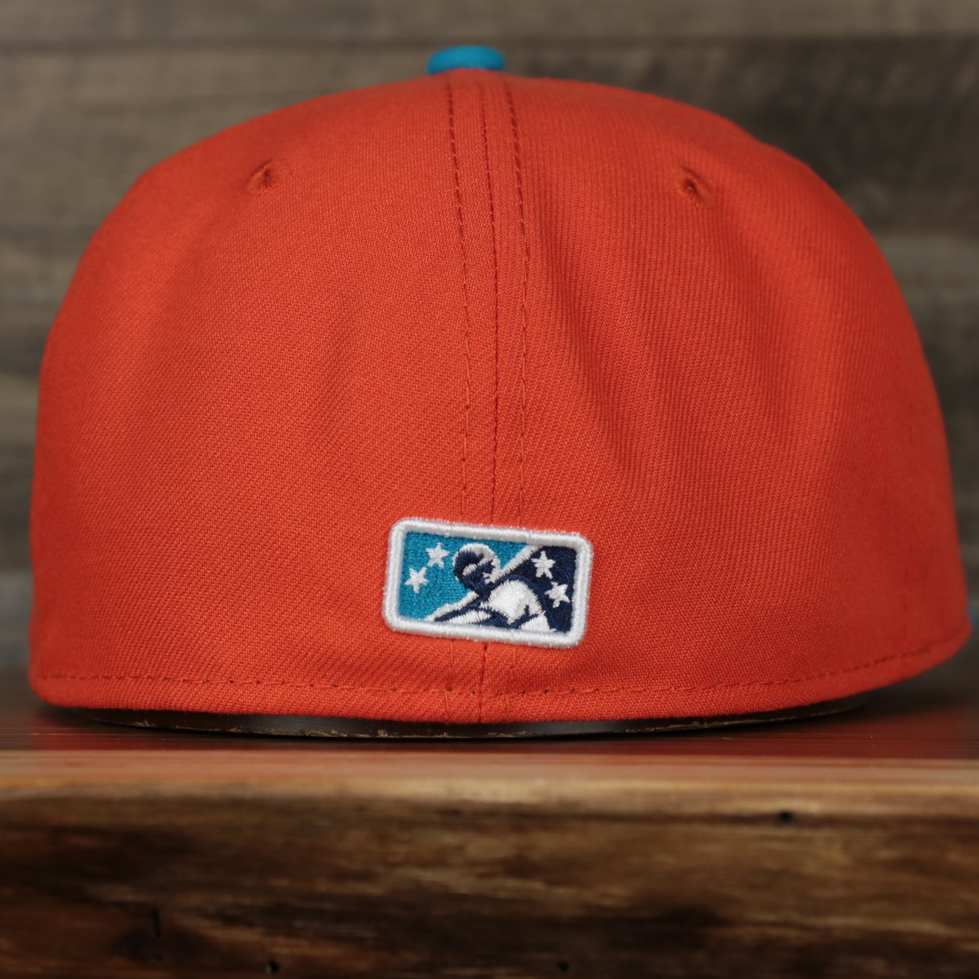 back of the Wisconsin Timber Rattlers 2022 Cascabeles de Wisconsin Copa On-Field Black Bottom 5950 Fitted Cap | Orange