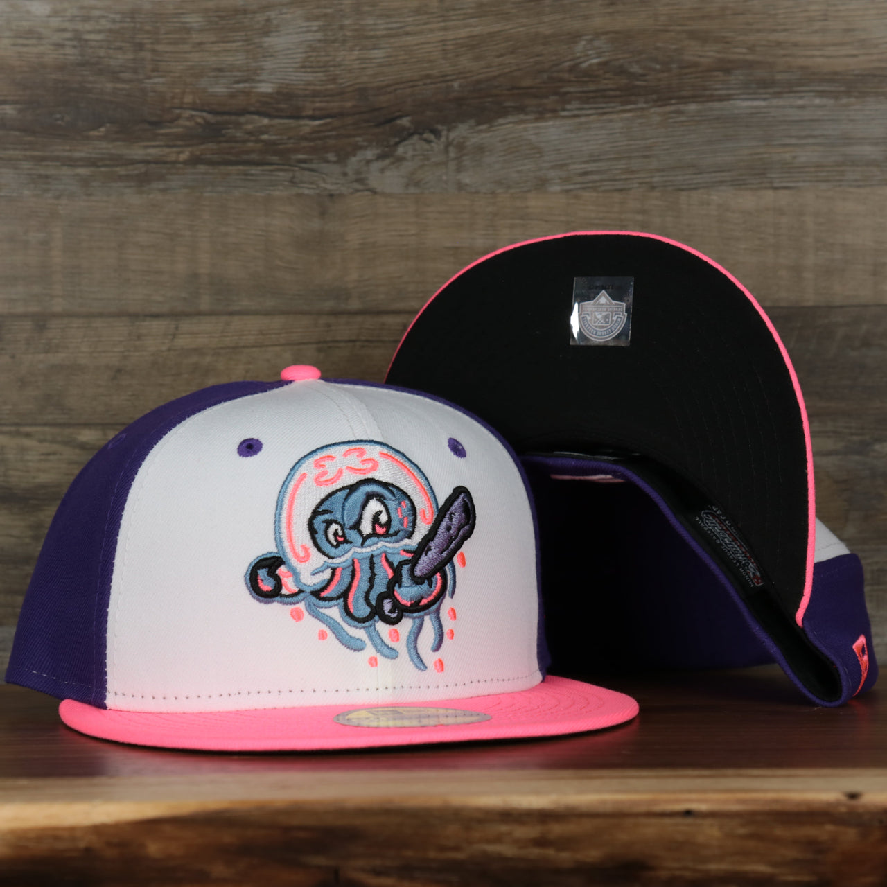 front and bottom of the Jersey Shore Blue Claws 2022 Medusas de Jersey Shore Copa de la Diversion On-Field Black Bottom 5950 Fitted Cap | Purple/White