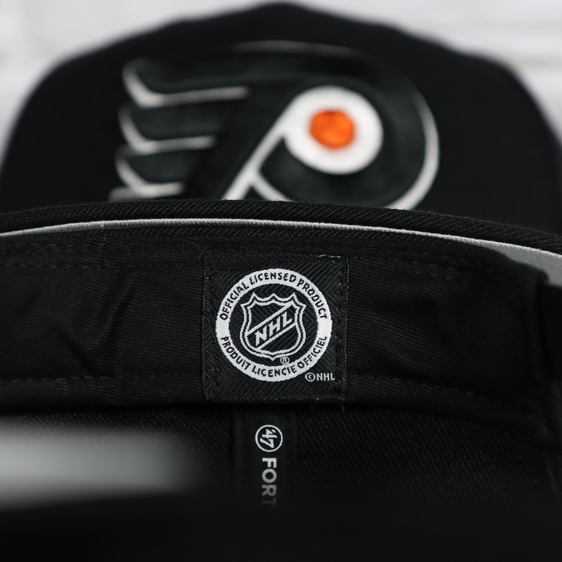 NHL Label on the interior of the Philadelphia Flyers No Shot Grey Undervisor Black Snapback Hat