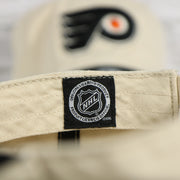 NHL label on the interior of the Philadelphia Flyers Natural Unstructured Crown Black Curved Brim Adjustable Dad Hat