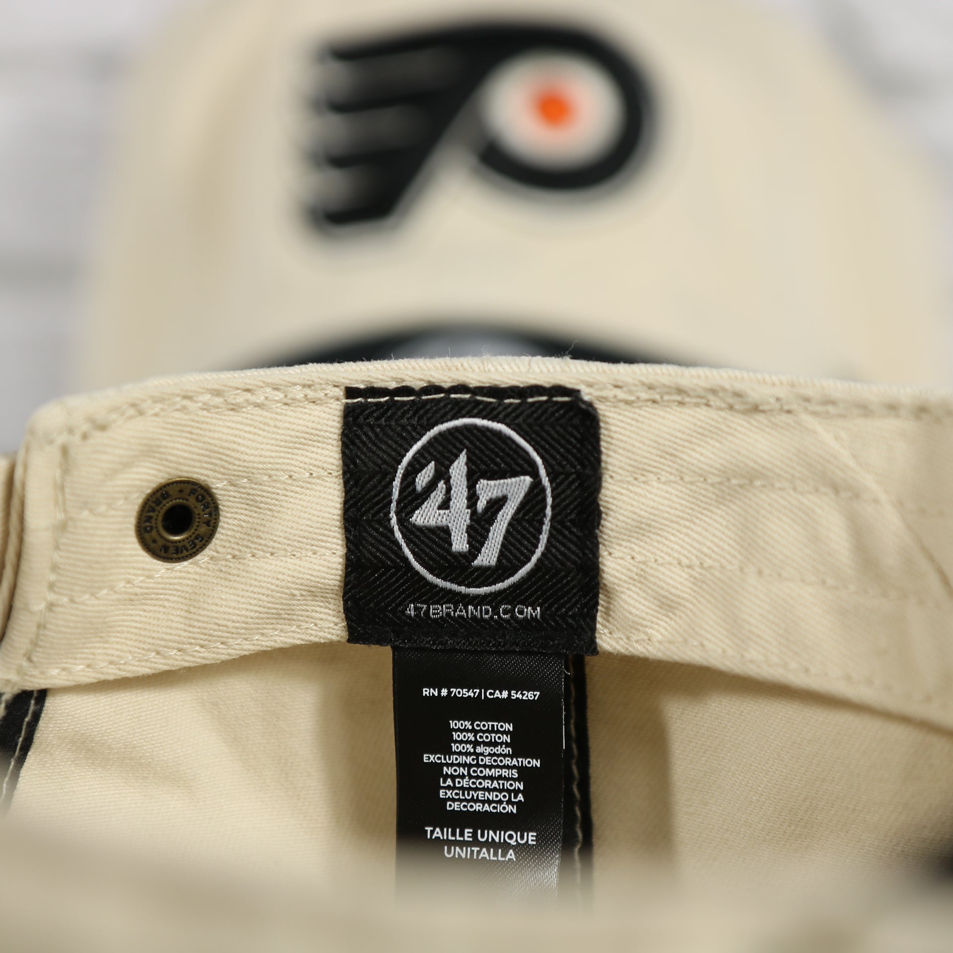 47 label on the interior of the Philadelphia Flyers Natural Unstructured Crown Black Curved Brim Adjustable Dad Hat