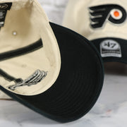 Black under visor of the Philadelphia Flyers Natural Unstructured Crown Black Curved Brim Adjustable Dad Hat