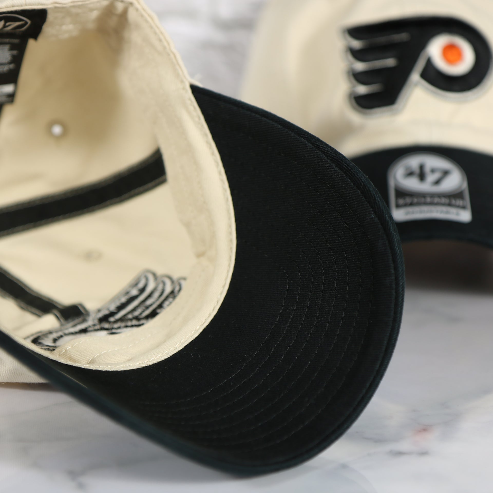 Black under visor of the Philadelphia Flyers Natural Unstructured Crown Black Curved Brim Adjustable Dad Hat
