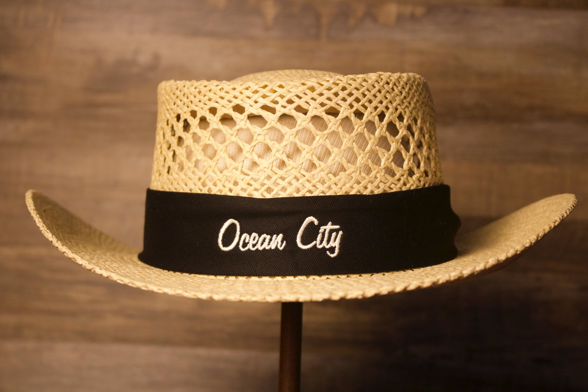 Ocean City Hat | Ocean City Natural Straw Hat the front of this ocean city straw hat has a black band all around and the words ocean city on the front 