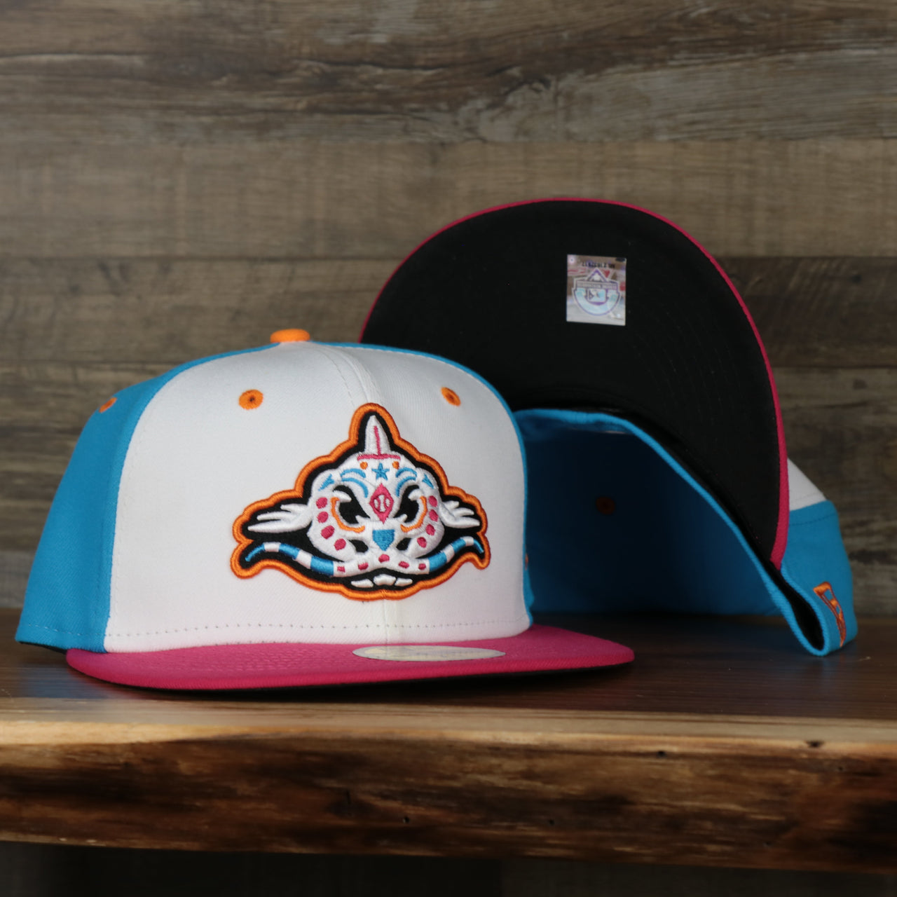 Front of the Carolina Mudcats 2022 Pescados de Carolina Copa de la Diversion On-Field Black Bottom 5950 Fitted Cap | White/Blue