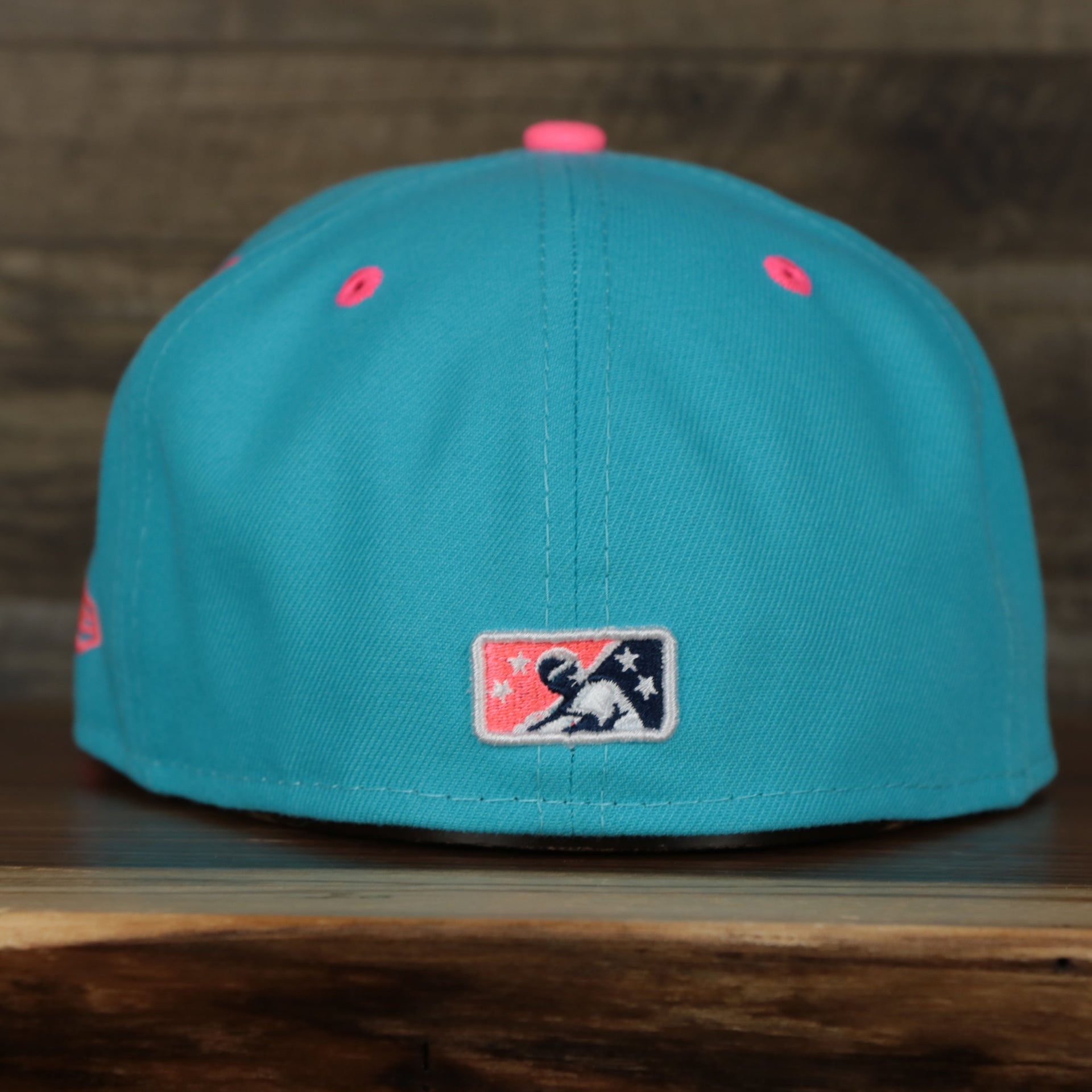 back of the Leigh Valley Iron Pigs 2022 Coquis de Leigh Valley Copa de la Diversion On-Field Black Bottom 5950 Fitted Cap | Blue/Pink