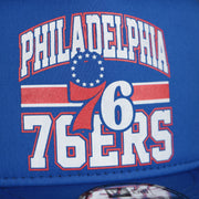76ers logo on the Philadelphia 76ers Trucker Gray Bottom 9Fifty Snapback | Blue | OSFM