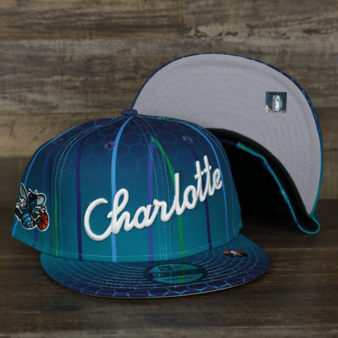 front and bottom of the Charlotte Hornets 2021 Retro City Edition Gray Bottom 9Fifty Snapback | Blue