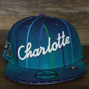 front of the Charlotte Hornets 2021 Retro City Edition Gray Bottom 9Fifty Snapback | Blue