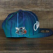 wearers right side of the Charlotte Hornets 2021 Retro City Edition Gray Bottom 9Fifty Snapback | Blue