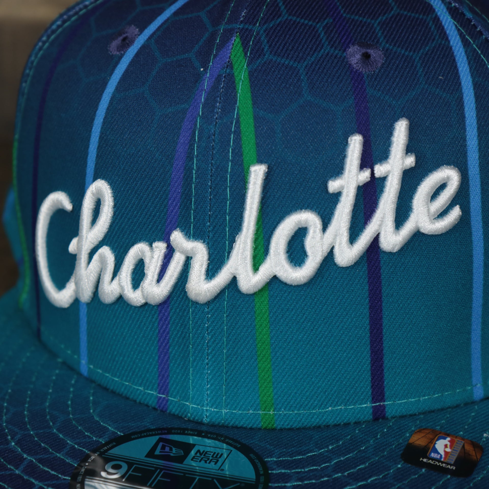 charlotte name on the Charlotte Hornets 2021 Retro City Edition Gray Bottom 9Fifty Snapback | Blue
