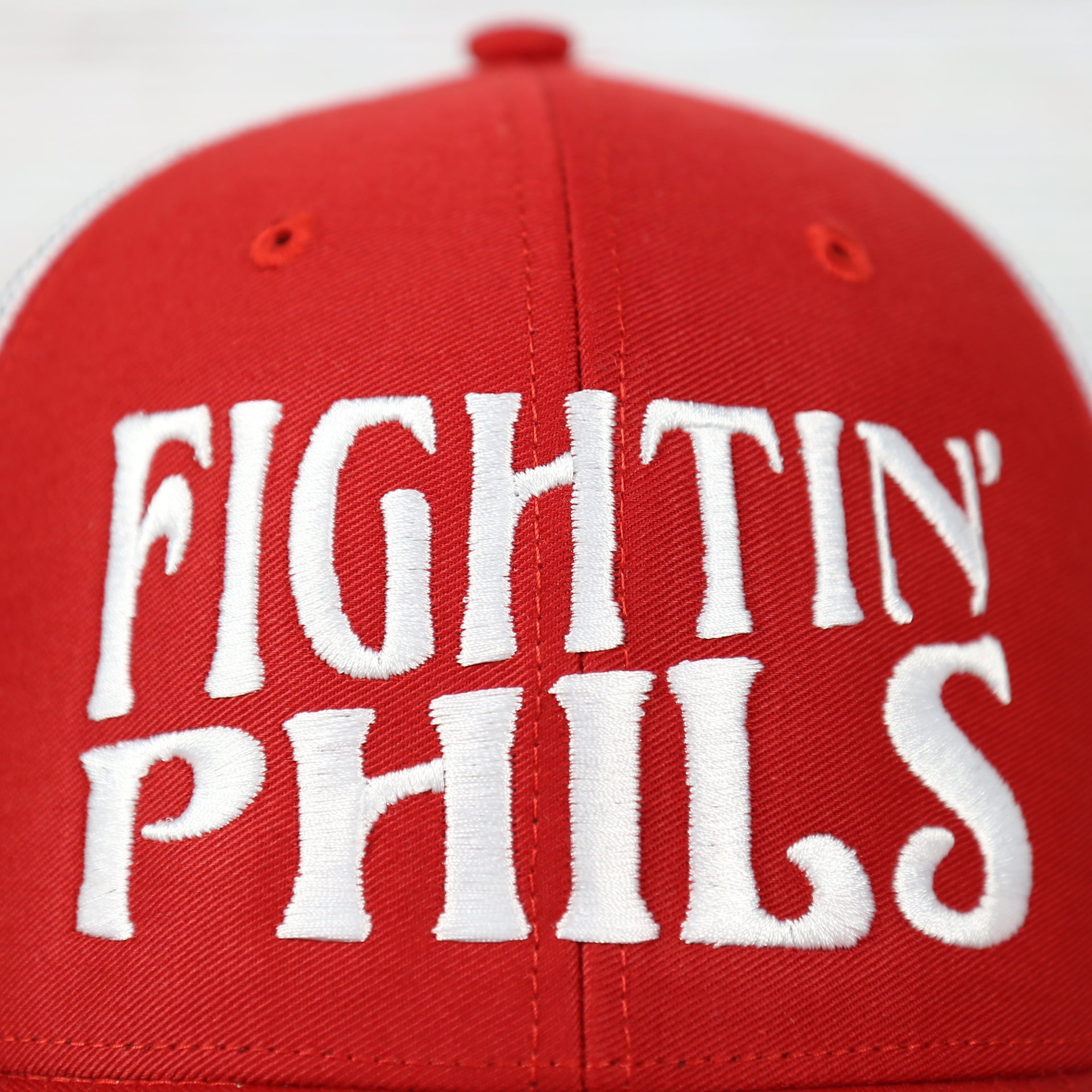 fightin phils slogan on the Philadelphia Phillies 2022 World Series Fightin' Phils Phillies Logo Side Patch Red Adjustable Trucker Snapback Hat