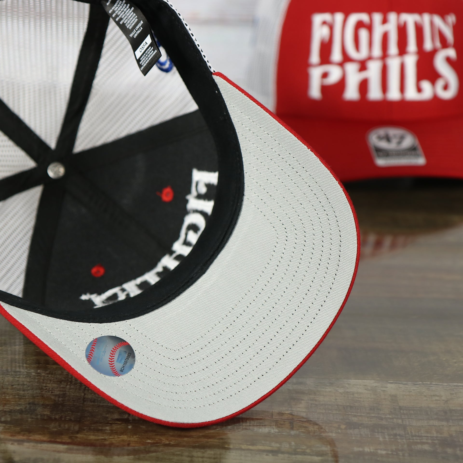 grey under visor of the Philadelphia Phillies 2022 World Series Fightin' Phils Phillies Logo Side Patch Red Adjustable Trucker Snapback Hat