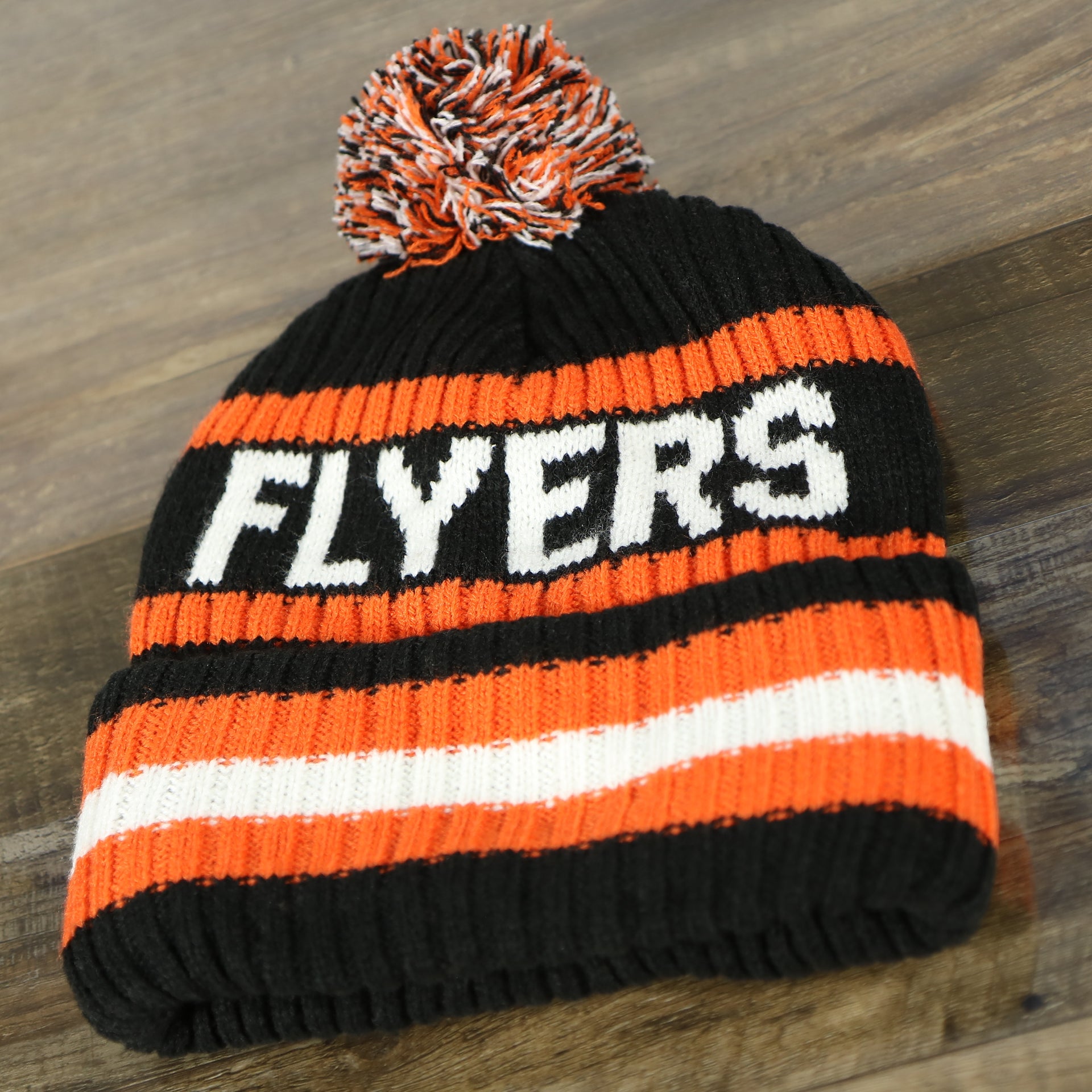 back side of the Philadelphia Flyers Two Sided Cuffed Winter Beanie | Orange, White, And Black Winter Beanie