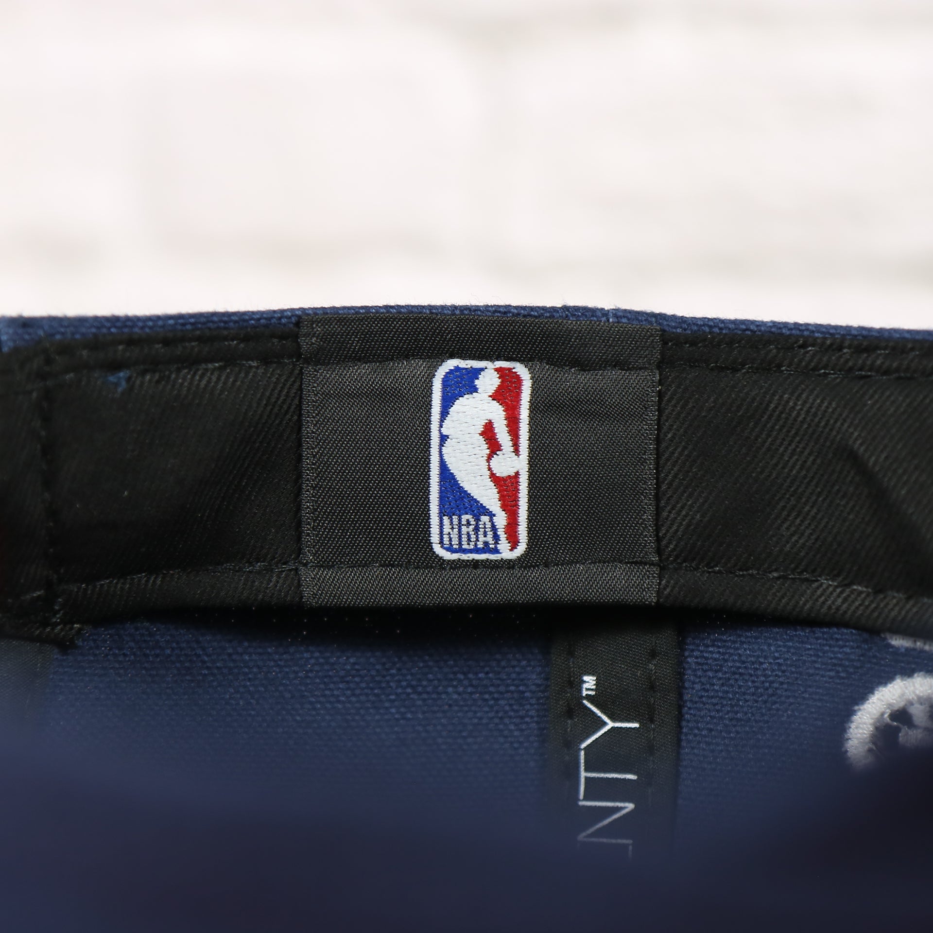 NBA label on the interior of the Philadelphia 76ers 2022 City Edition Sixers Script Spectrum Side Patch 9Twenty Dad Hat