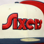 Close up of the Sixers script wordmark on the front of the Philadelphia 76ers 2022 City Edition Sixers Script Spectrum Side Patch Chrome/Navy 59Fifty Fitted Cap