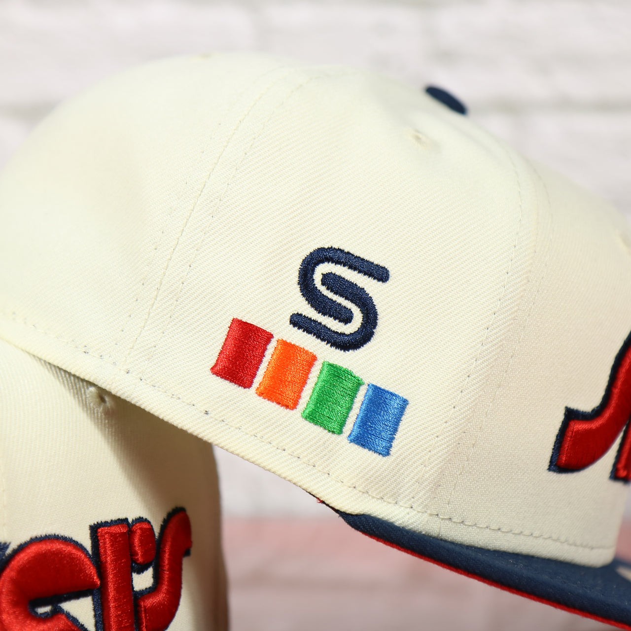 Close up of the side patch on the Philadelphia 76ers 2022 City Edition Sixers Script Spectrum Side Patch Chrome/Navy 59Fifty Fitted Cap