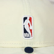 Close up of the NBA logo on the back of the Philadelphia 76ers 2022 City Edition Sixers Script Spectrum Side Patch Chrome/Navy 59Fifty Fitted Cap