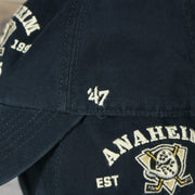 47 brand logo on the Anaheim Ducks Throwback Distressed Black Dad Hat | Black Adjustable Baseball Cap