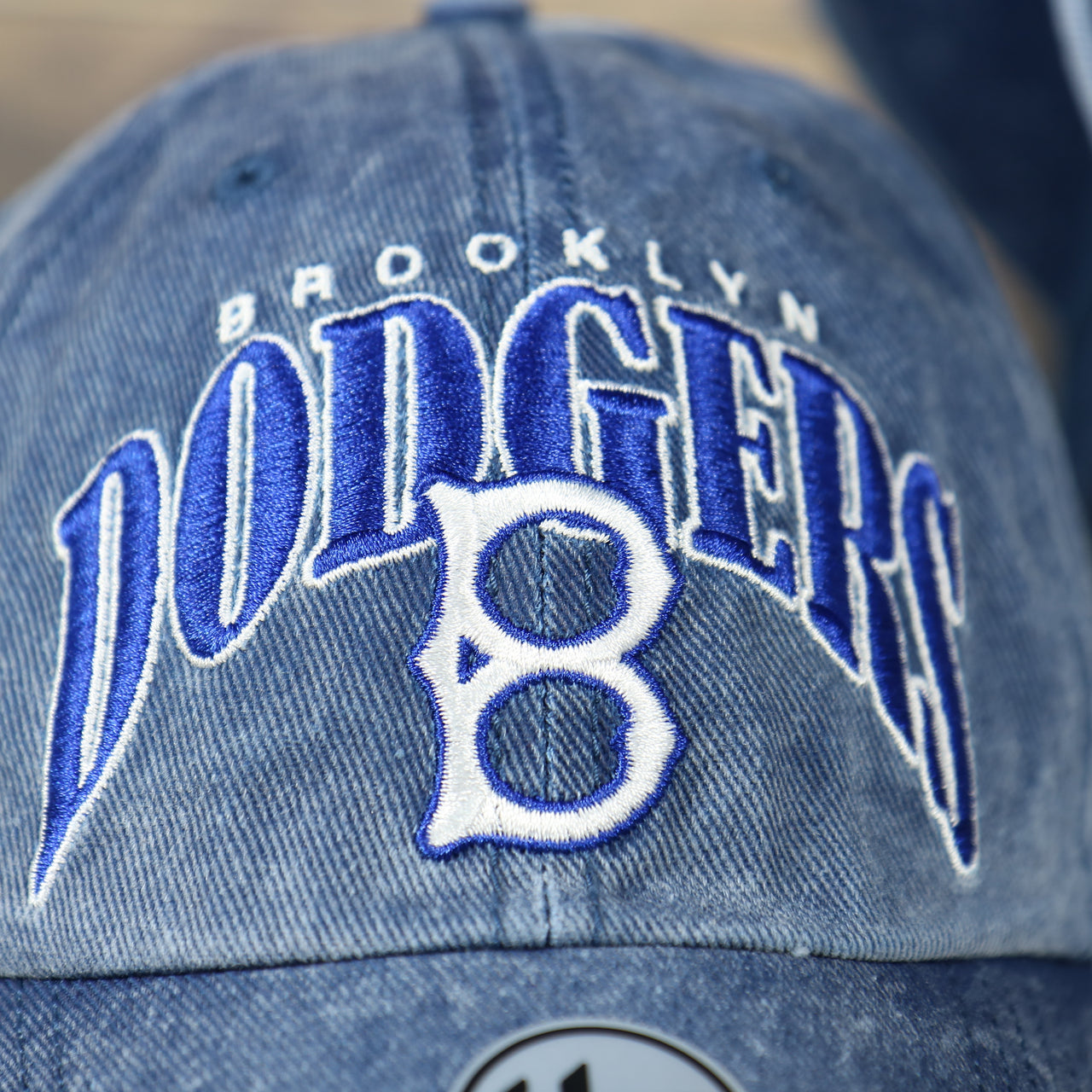 logo on the front of the Brooklyn Dodgers Throwback Distressed Blue Dad Hat | Blue Adjustable Baseball Cap