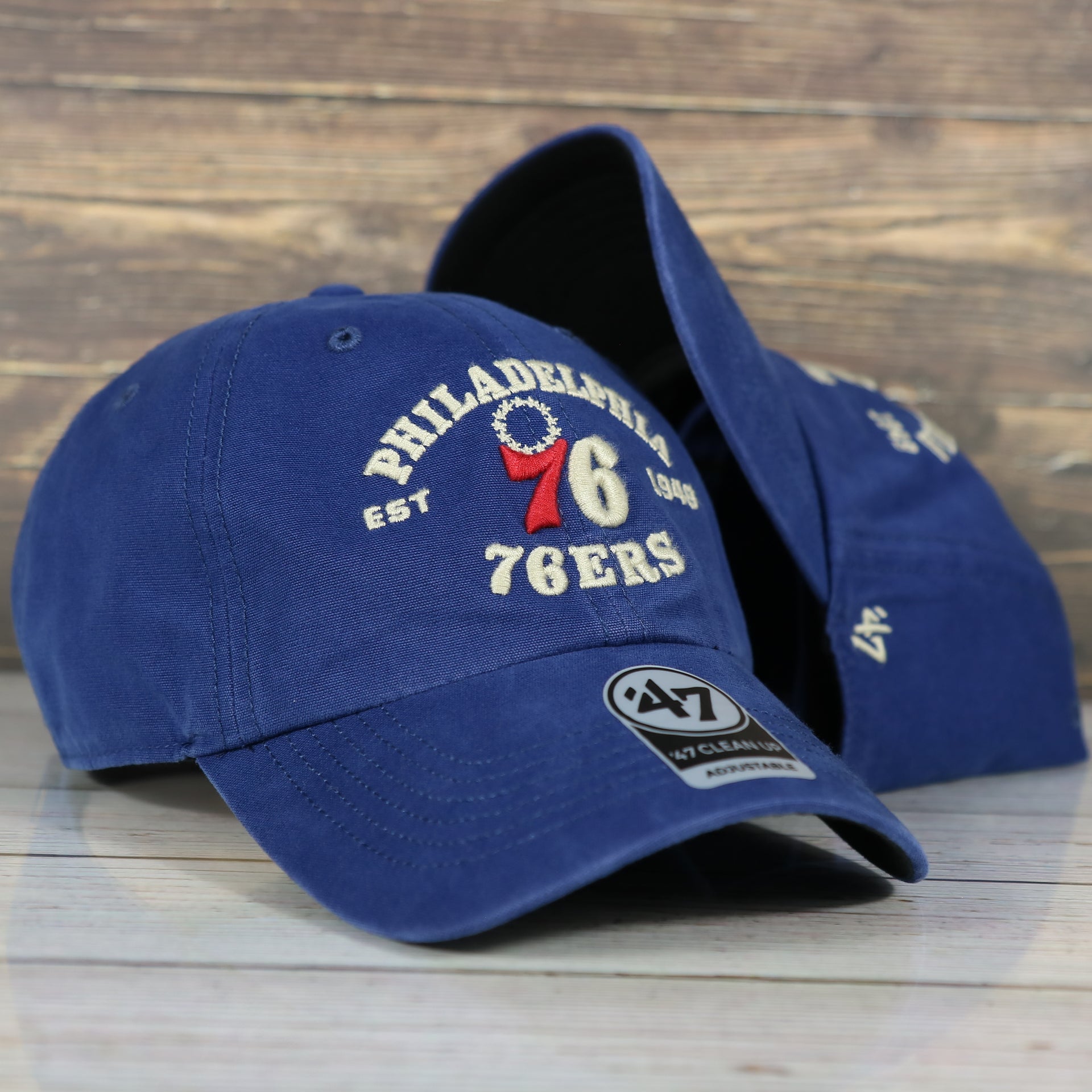 front and underside of the Philadelphia 76ers Throwback Distressed Blue Dad Hat | Blue Adjustable Baseball Cap