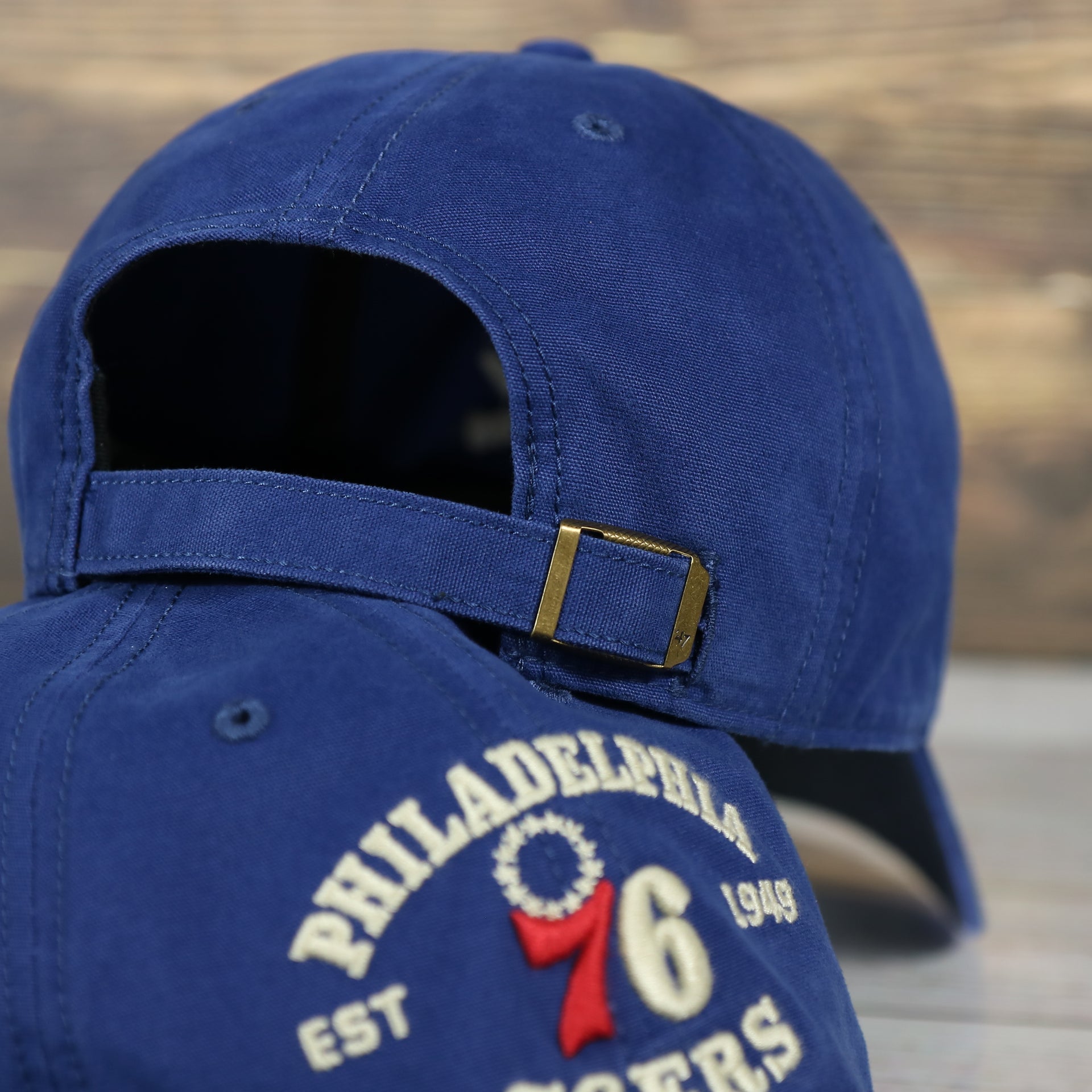 backside of the Philadelphia 76ers Throwback Distressed Blue Dad Hat | Blue Adjustable Baseball Cap