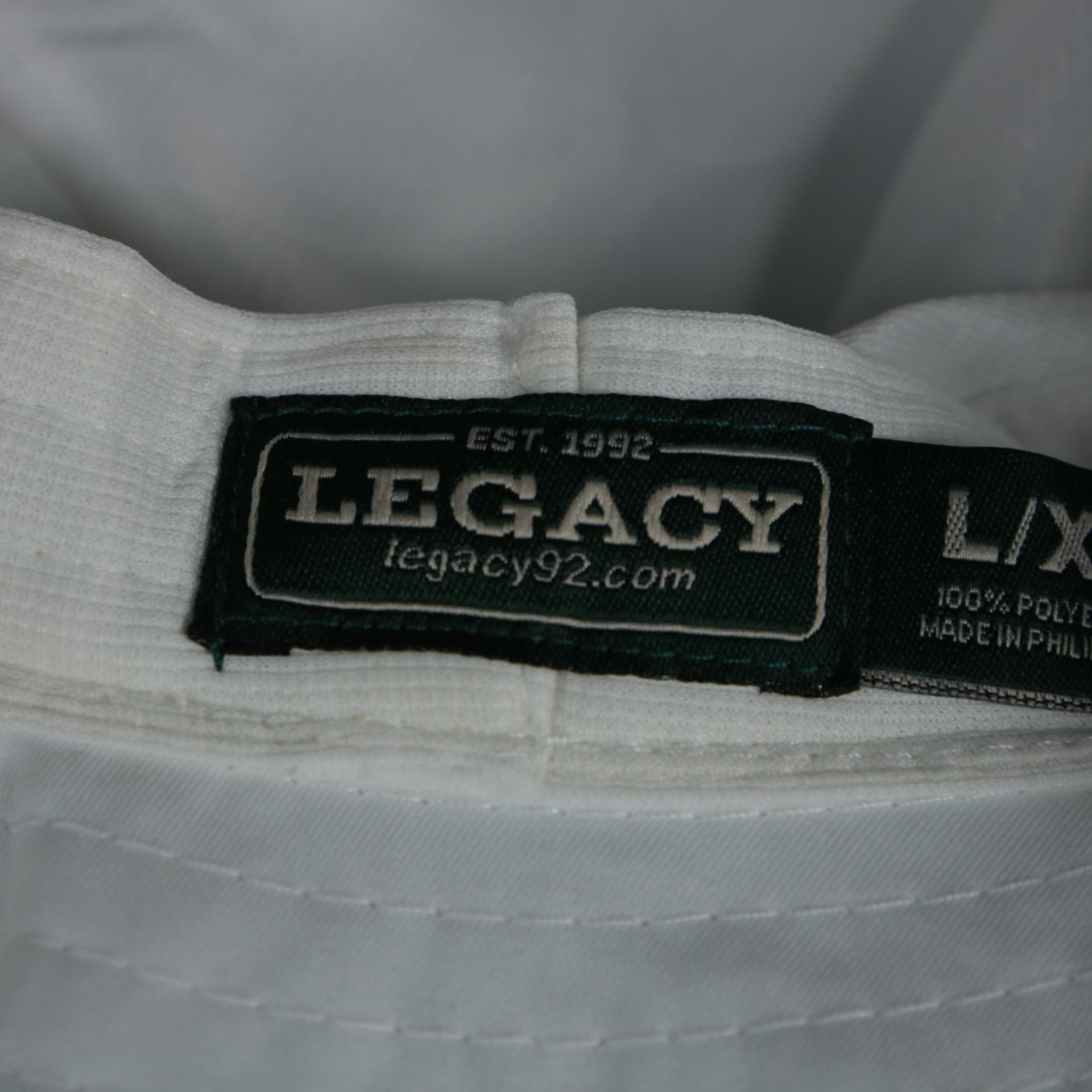 A close up of the Legacy tag on the Ocean City Wildwood League Legacy Bucket Hat