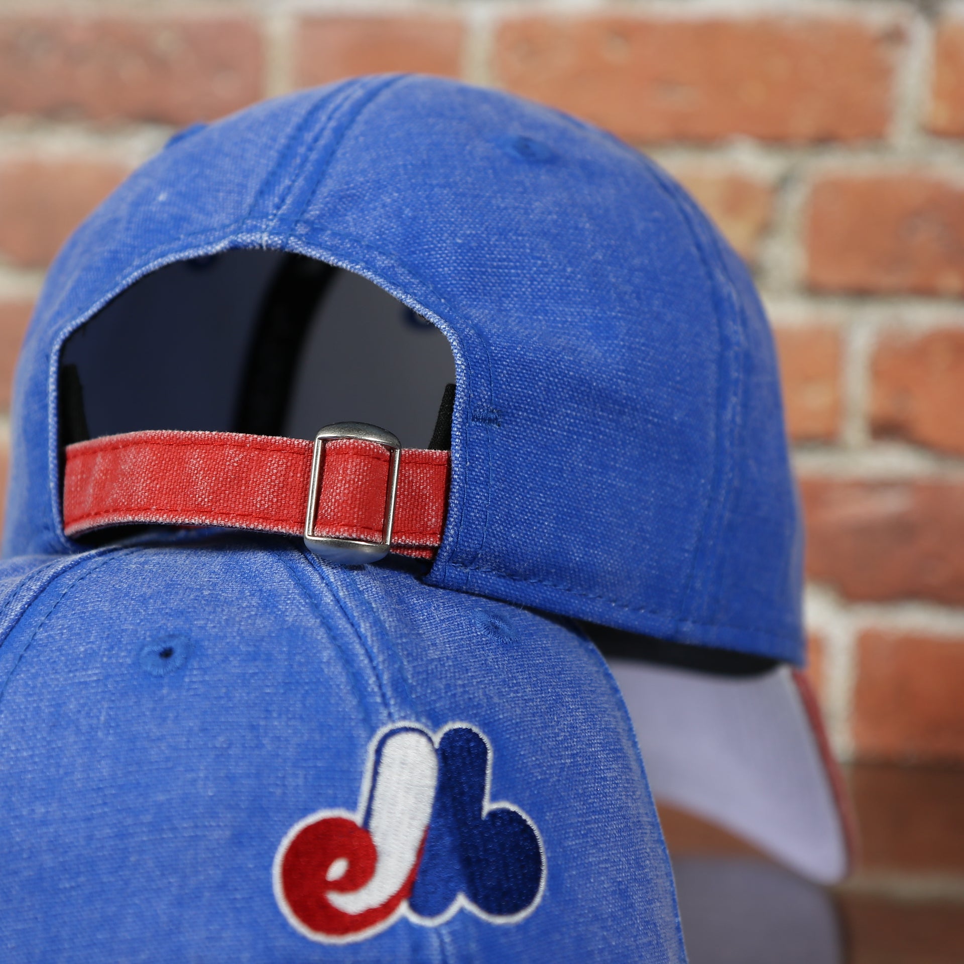 back side of the Montreal Expos Throwback Distressed Denim Blue Women's Dad Hat | Blue Adjustable Baseball Cap