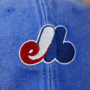 expos logo on the front of the Montreal Expos Throwback Distressed Denim Blue Women's Dad Hat | Blue Adjustable Baseball Cap